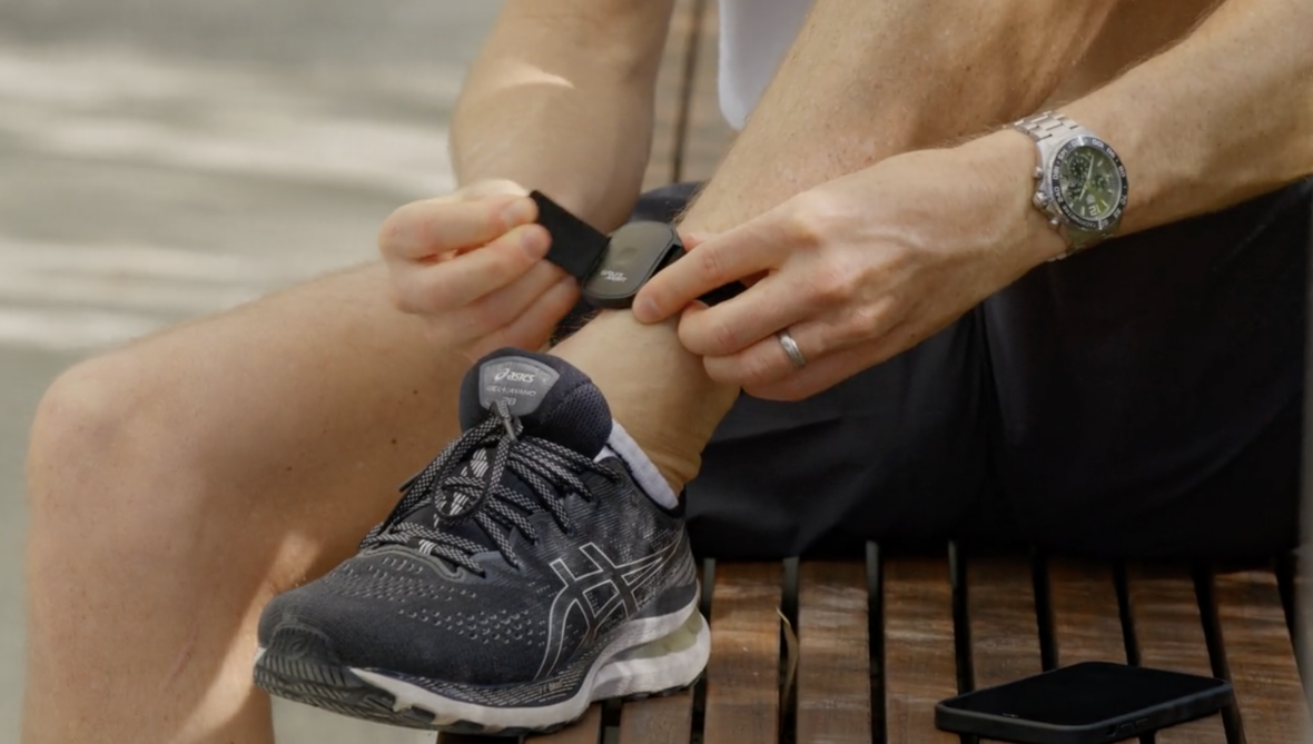 man wears a fitness tracker on his ankle